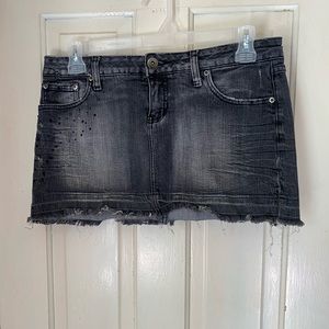 Distressed black denim mini skirt